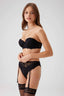 A model showcasing the Whisper lace lingerie set from the front, featuring a strapless push-up bra with intricate floral lace, paired with a matching garter belt and lace stockings.